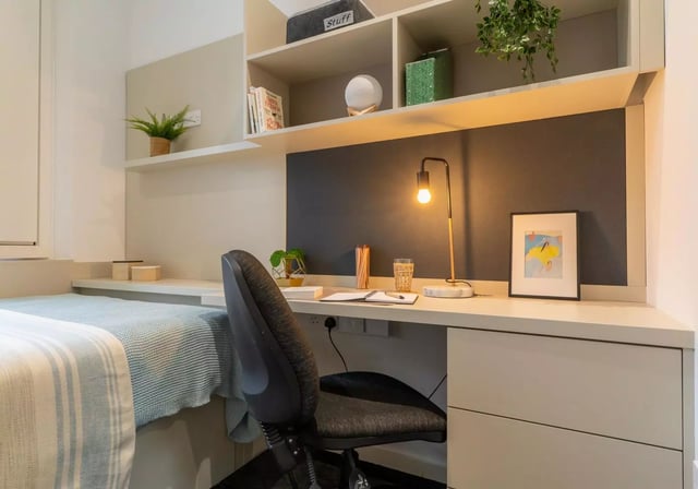 Bed desk chair and shelves student room at iQ Vega London in London Student Accommodation