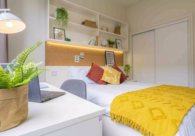 Desk bed plants and wardrobe bedroom at iQ Fletcher House in Manchester Student Accommodation