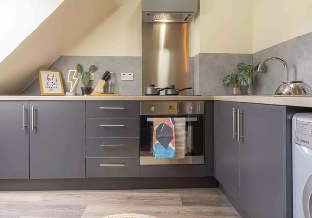 Modern grey cabinets oven toaster and sink kitchen at iQ Fletcher House in Manchester Student Accommodation
