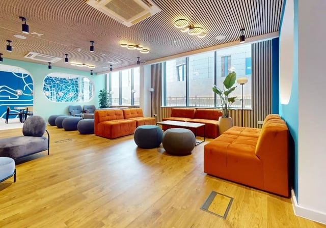 Orange sofas blue ottomans coffee table living room at iQ Nelson Court in Nottingham Student Accommodation