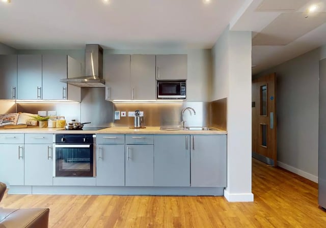 Modern grey kitchen with oven microwave and sink kitchen at iQ Knight House in Sheffield Student Accommodation