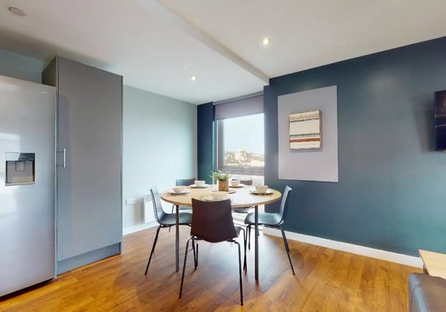 Round table four chairs silver fridge kitchen at iQ Knight House in Sheffield Student Accommodation