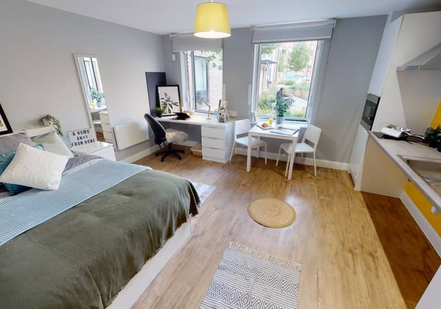 Bed desk table kitchen area studio apartment at iQ The Brickworks in York Student Accommodation