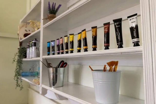Paint tubes and art supplies on shelves Study area at Queen Alexandra's House in London Student Accommodation