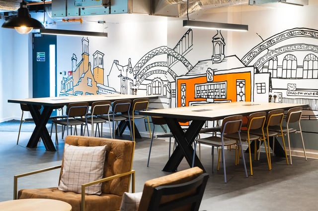 Tables chairs with artwork in student accommodation common area at Altura Birmingham in Birmingham Student Accommodation