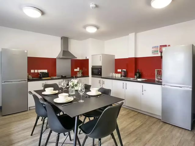 Dining table with place settings and chairs kitchen at Bright House in Kingston Upon Thames Student Accommodation
