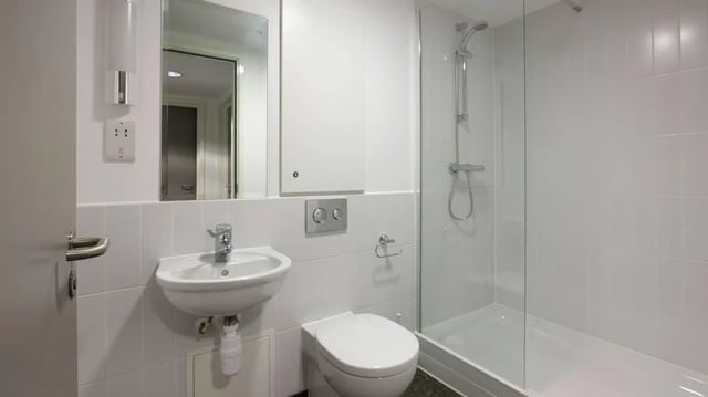 Sink toilet shower Mirror bathroom at Treliske Key Workers in Truro Student Accommodation