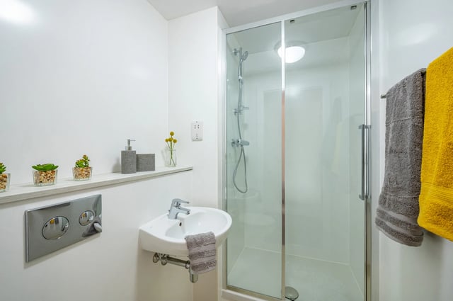 Sink shower glass door towels bathroom at Foundry Studios in Lancaster Student Accommodation