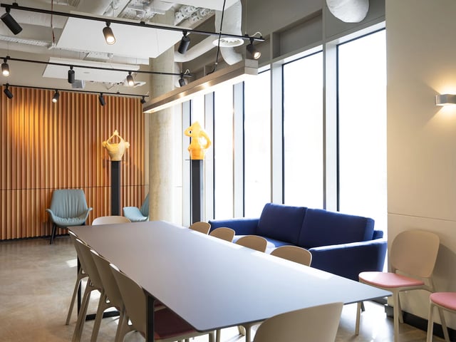 Dining table sofa chairs with decor living room at The Terry Frost Building in Leeds Student Accommodation
