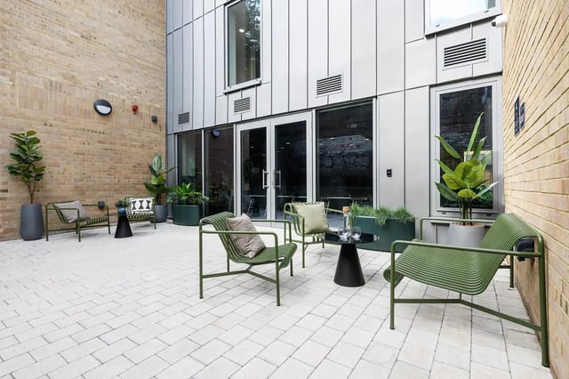 Green chairs table plants courtyard patio at Huxley Studios in Edinburgh Student Accommodation