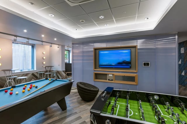 Pool table foosball table television playing area at Kaplan Living West Village in Glasgow Student Accommodation