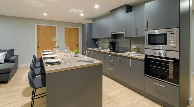 Island dining area modern grey kitchen kitchen at Symons House in Leeds Student Accommodation