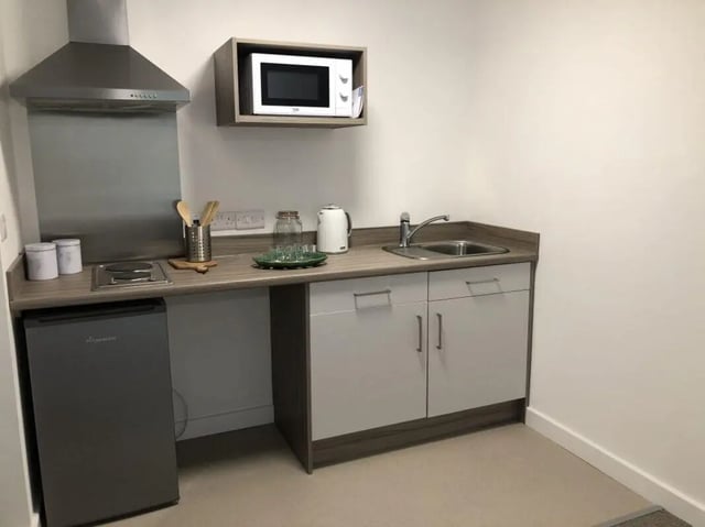 Countertop with sink microwave hob and fridge kitchen at Q Studios in Stoke-On-Trent Student Accommodation