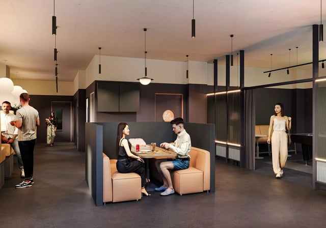 Couple eating pizza in dining booths lounge area at Longwood Place in Coventry Student Accommodation