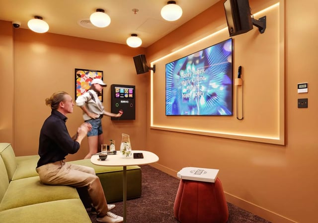 Karaoke machine people pizza and screen playing area at Longwood Place in Coventry Student Accommodation