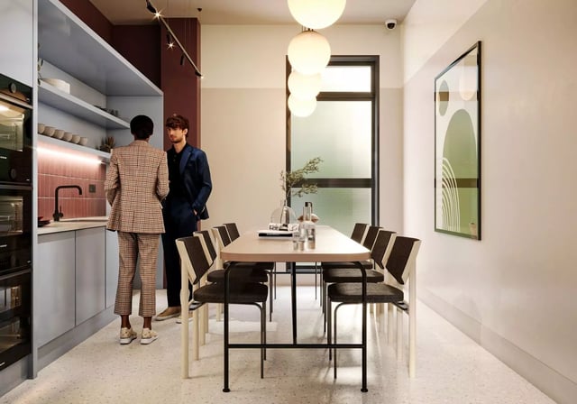 Kitchen with people and dining table common area at Longwood Place in Coventry Student Accommodation