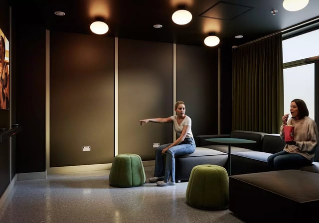 Women watching TV with popcorn living room at Longwood Place in Coventry Student Accommodation