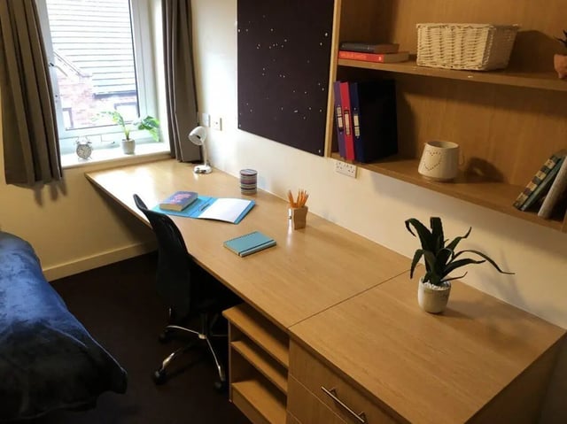Desk with chair plants books and stationery study area at Foundry 1 in Loughborough Student Accommodation