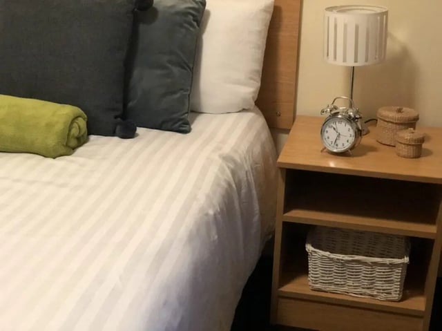 Bed with pillows and rolled towel bedside table bedroom at Foundry 1 in Loughborough Student Accommodation