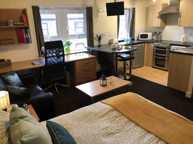 Bed desk kitchen and sofa student studio room at Foundry 1 in Loughborough Student Accommodation
