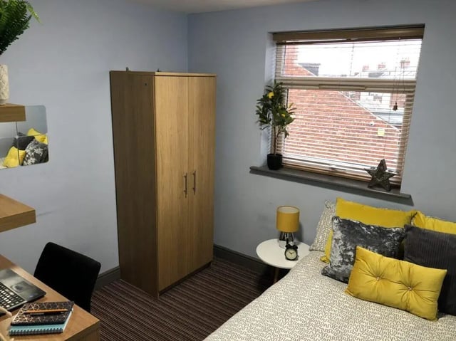Wardrobe bed pillows desk and chair bedroom at Millfield House in Sunderland Student Accommodation