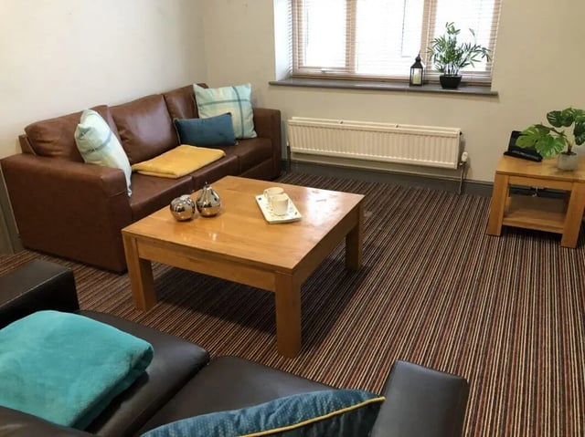 Brown leather sofa coffee table living room at Millfield House in Sunderland Student Accommodation