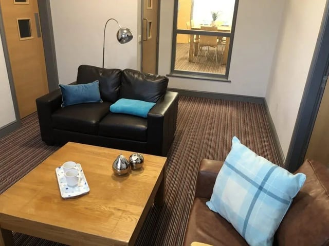 Black sofa coffee table with cups and decor living room at Millfield House in Sunderland Student Accommodation