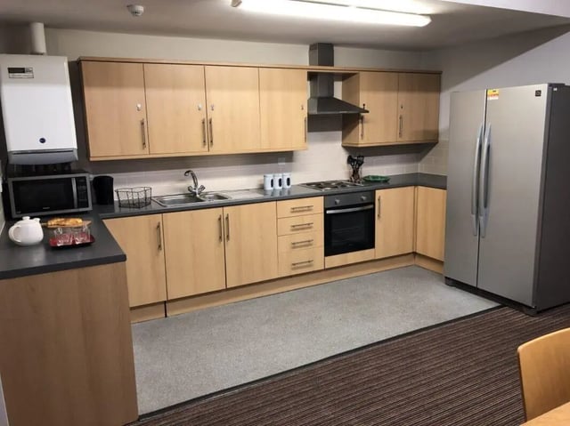 Cabinets microwave fridge sink stove oven kitchen at Millfield House in Sunderland Student Accommodation