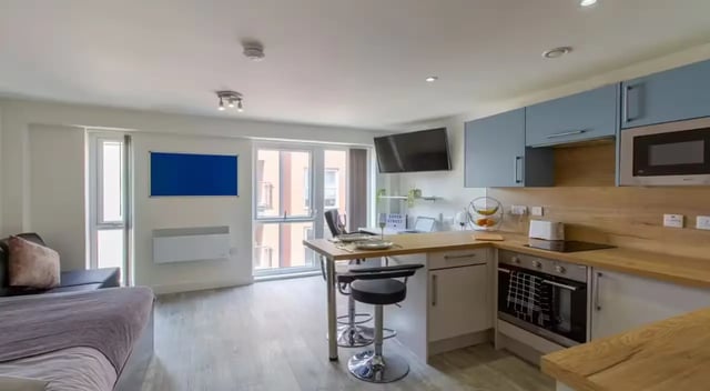 Studio apartment with sofa kitchen and dining table studio living room at Dover Street Apartments in Leicester Student Accommodation