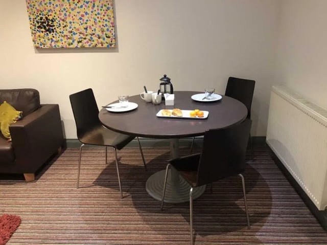 Round table with chairs and artwork living room at Norflok Street in Sunderland Student Accommodation