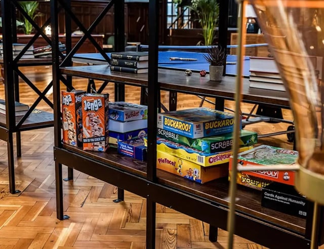 Books and board games on shelves leisure area at John Bell House in Belfast Student Accommodation