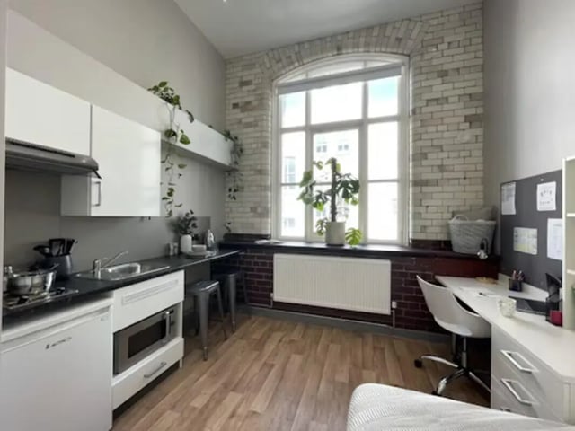 Kitchenette, study area with desk and chair, bedroom. at John Bell House in Belfast Student Accommodation