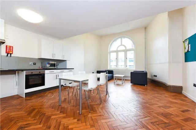 Kitchen table and sofas living room at John Bell House in Belfast Student Accommodation