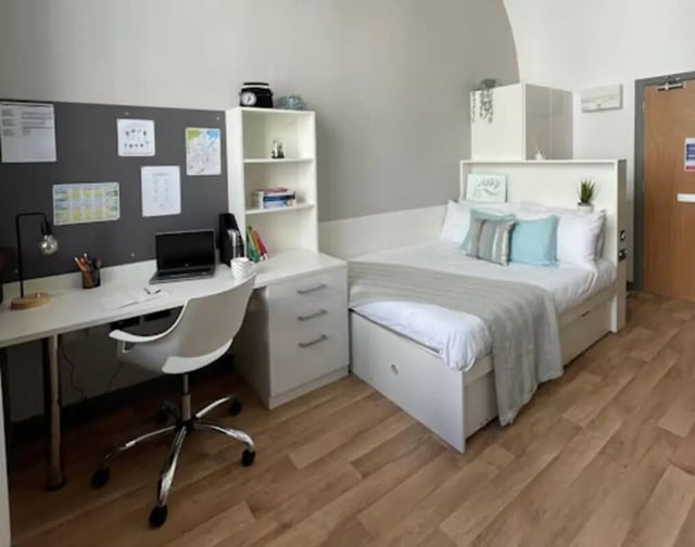 Desk bed shelf and chair student room at John Bell House in Belfast Student Accommodation