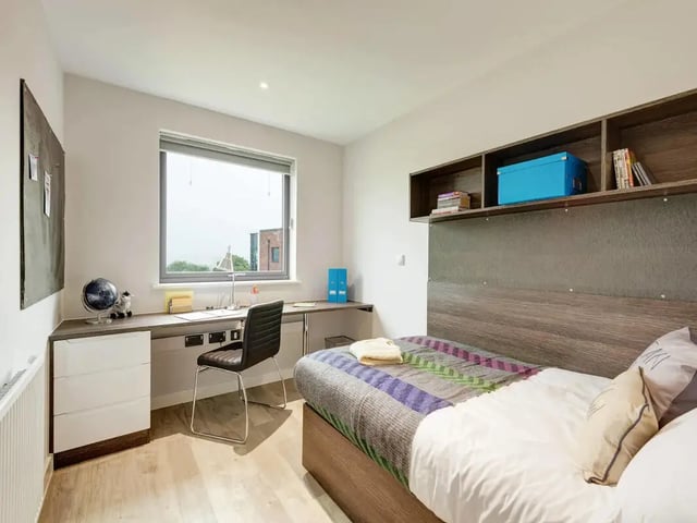 Bed desk globe chair shelves blue box bedroom at Cricket Field Court in Exeter Student Accommodation