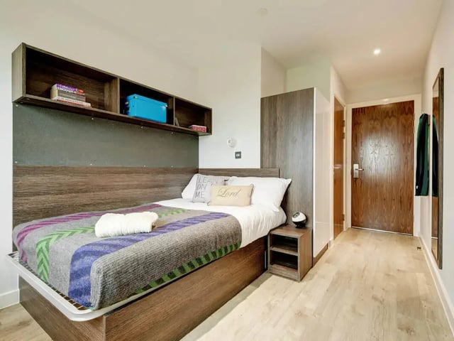 Bed with shelving and side table bedroom at Cricket Field Court in Exeter Student Accommodation