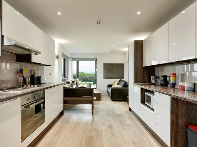 Modern kitchen with dining area and lounge living room at Cricket Field Court in Exeter Student Accommodation