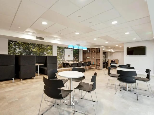 Modern lounge with tables chairs and booths common area at Cricket Field Court in Exeter Student Accommodation