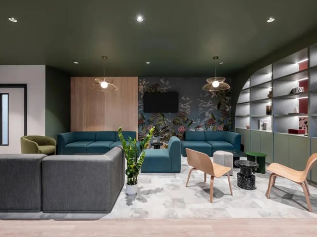 Modern lounge with sofas chairs and shelving living room at Dunaskin Mill in Glasgow Student Accommodation