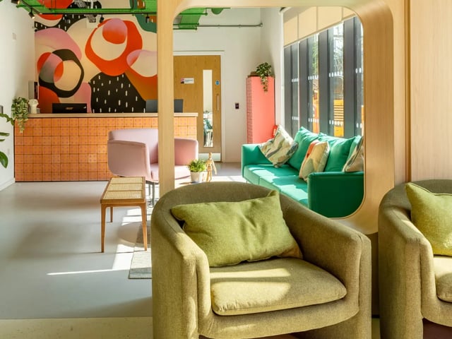 Modern reception area with sofas and chairs. at The Brook in Bath Student Accommodation