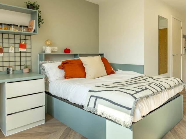 Bed desk shelf storage jars pillows and blanket bedroom at The Brook in Bath Student Accommodation