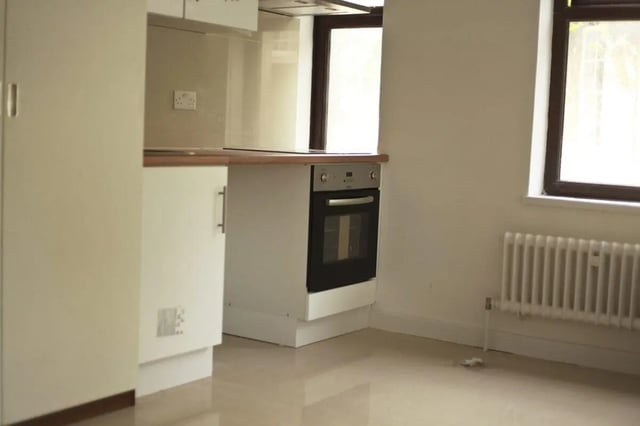 White cabinets oven and radiator kitchen at The Brook in Bath Student Accommodation