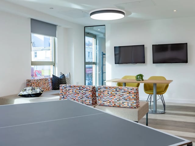 Ping pong table two TVs and table living room at Pavilion Point in Brighton Student Accommodation