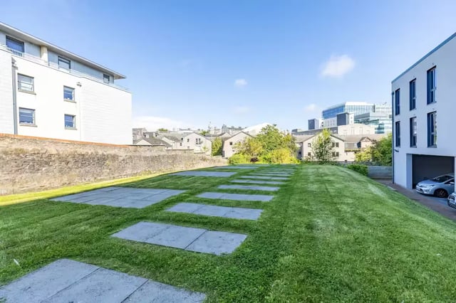 Grass and stone path with apartment buildings exterior at Abeleven in Aberdeen Student Accommodation