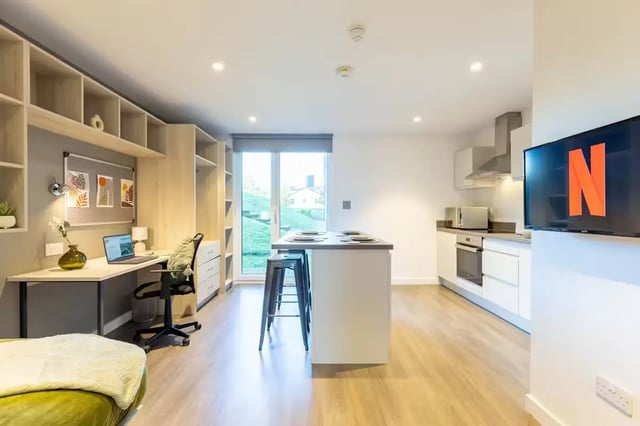 Desk kitchen island television and bed living area at Abeleven in Aberdeen Student Accommodation