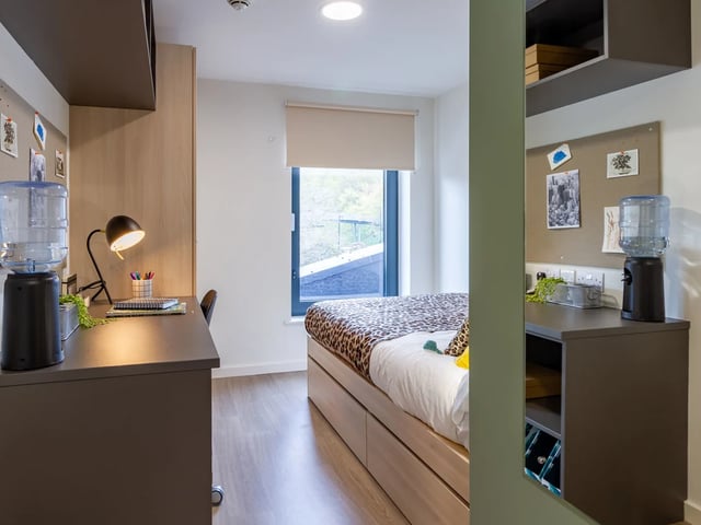 Desk water cooler lamp and bed bedroom at Dun Holm House in Glasgow Student Accommodation