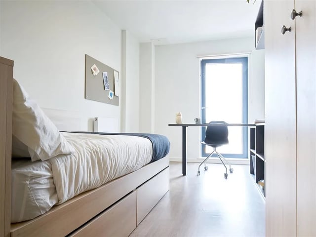 Bed desk chair and window Bedroom at Dun Holm House in Glasgow Student Accommodation