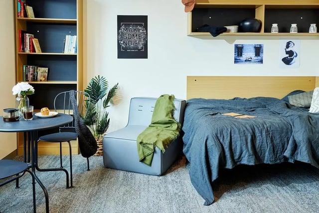 Bookshelf chair bed desk plants posters bedroom at Scape Queensberry in Melbourne Student Accommodation