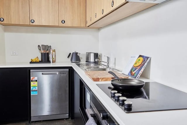 Kitchen with dishwasher toaster kettle and induction hob at Scape Queensberry in Melbourne Student Accommodation