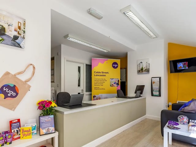 Reception desk with laptops and flowers reception area at Cable Street Lancaster in Lancaster Student Accommodation